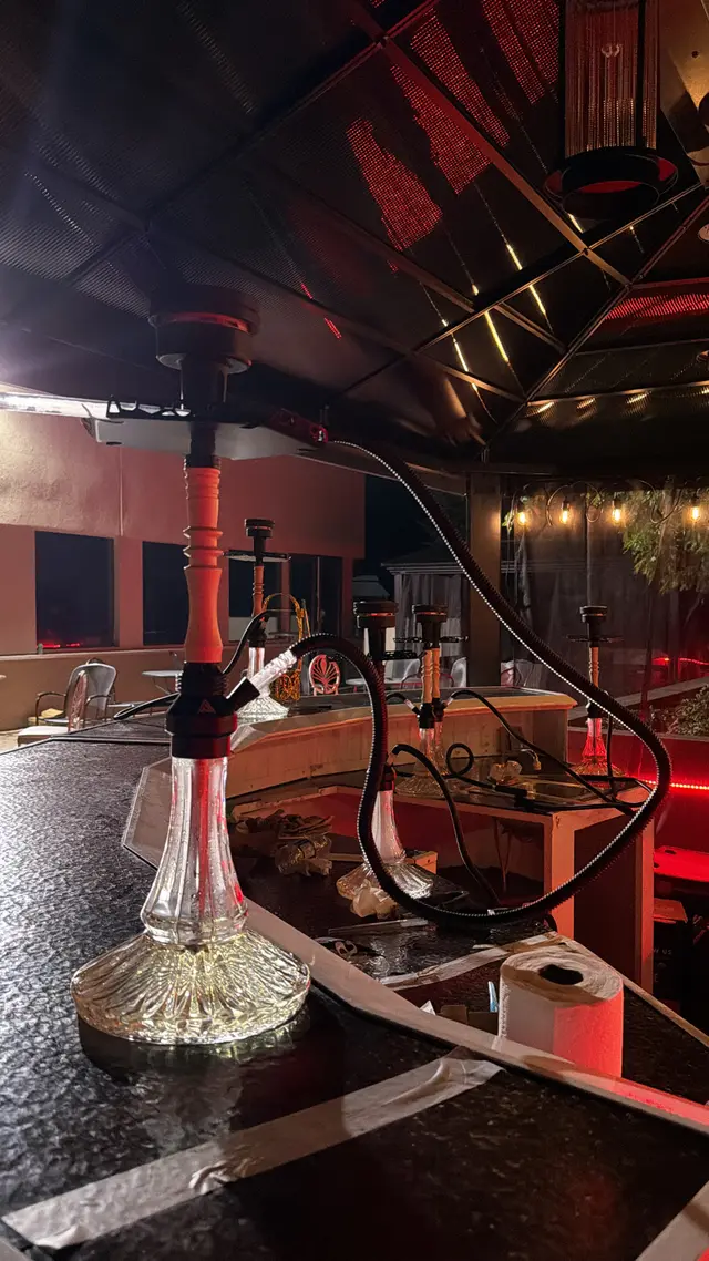 Hookah on a table in a red-lit bar