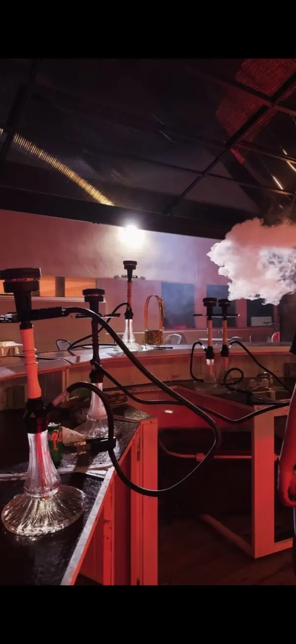 Hookah on the bar of a red-lit venue